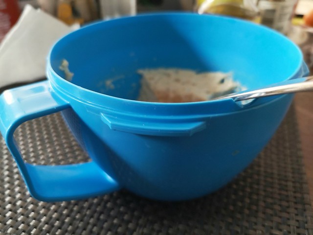 blue plastic soup mug with a handle and spoon