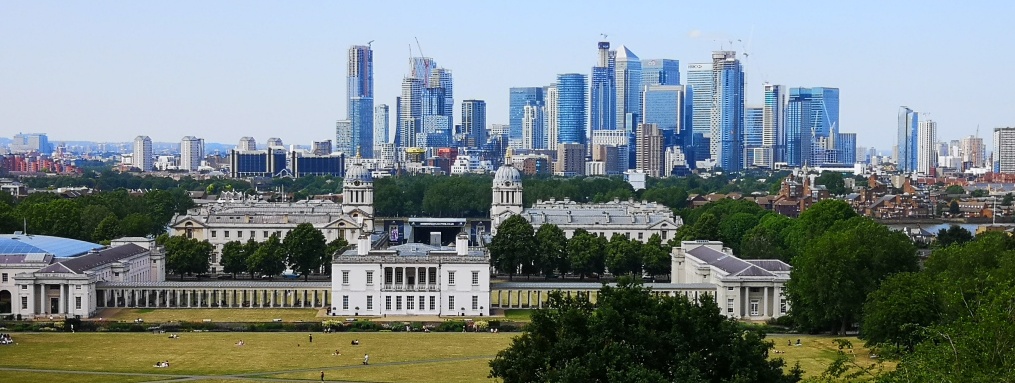 Greenwich landscape from the Observatory with tall buildings in the back with historical buildings in the foreground