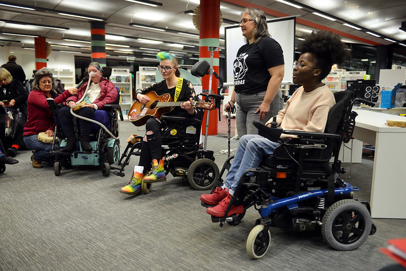 part of the evening performers, 2 wheelchair users with guitars