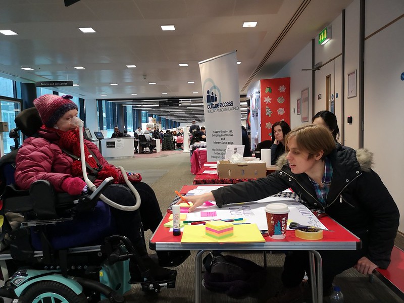 wheelchair woman at an information stall