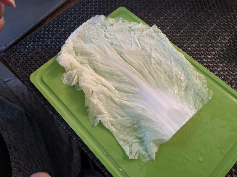 cabbage leaf on green chopping board