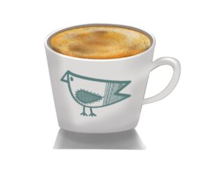 cake in a white mug with green cartoon drawn bird